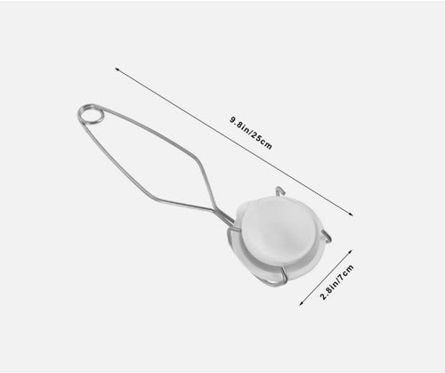 Close-up of the crucible dish and pinch tongs set, showing their robust construction.