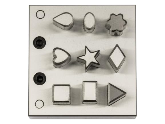 Close-up of assorted shaped punch openings on the steel disc cutter.