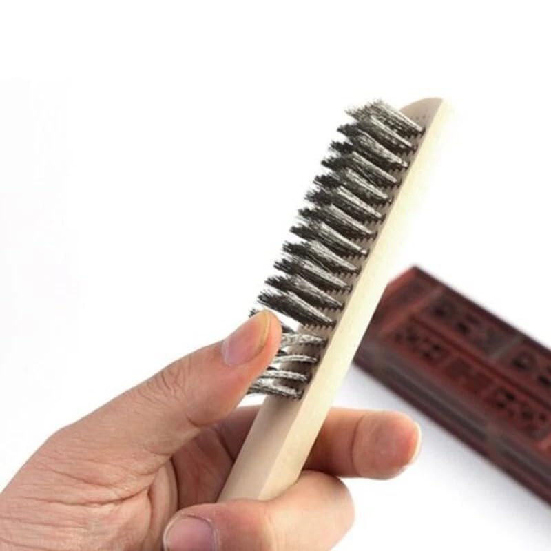 Close-up of steel bristles on wooden handle wire brush for metal cleaning