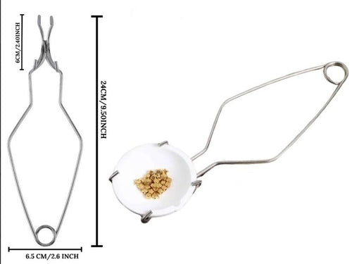 Close-up of the crucible dish and stainless steel whip tongs for metal melting