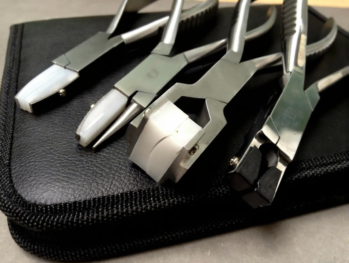 Close-up of the parallel-action jaws of the optical pliers, showing their smooth nylon faces for delicate work.