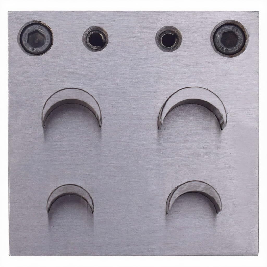 Close-up of four crescent-shaped steel punches for jewellery making, sizes 9-21mm