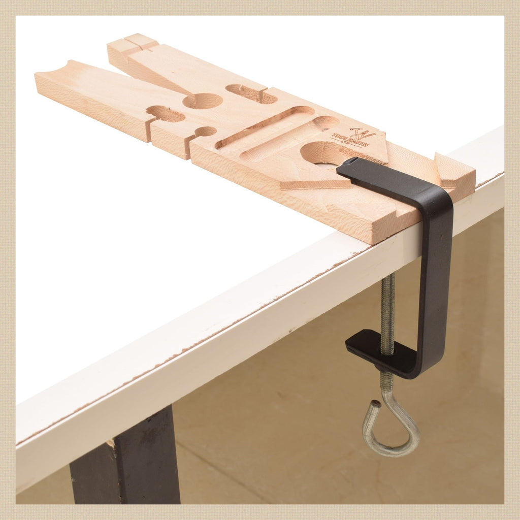 Multi-angled bench pin clamped to the edge of a workbench