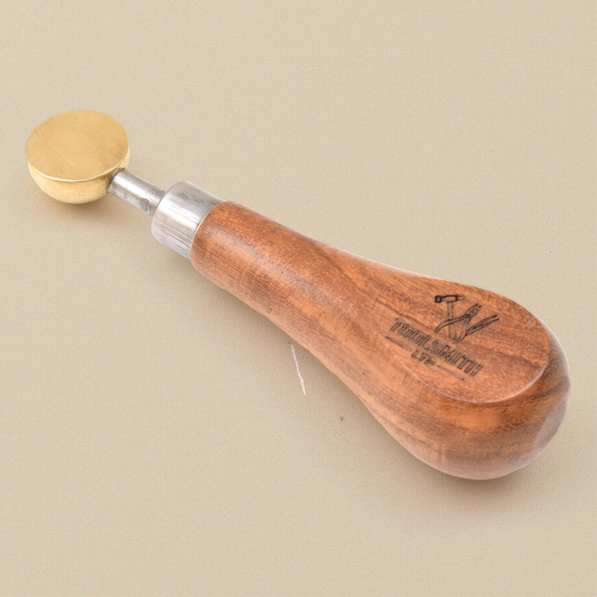 Brass bezel pusher from above, showing the round head