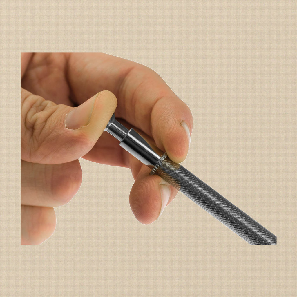 Pressing the spring-loaded plunger of the 4-prong gem holder