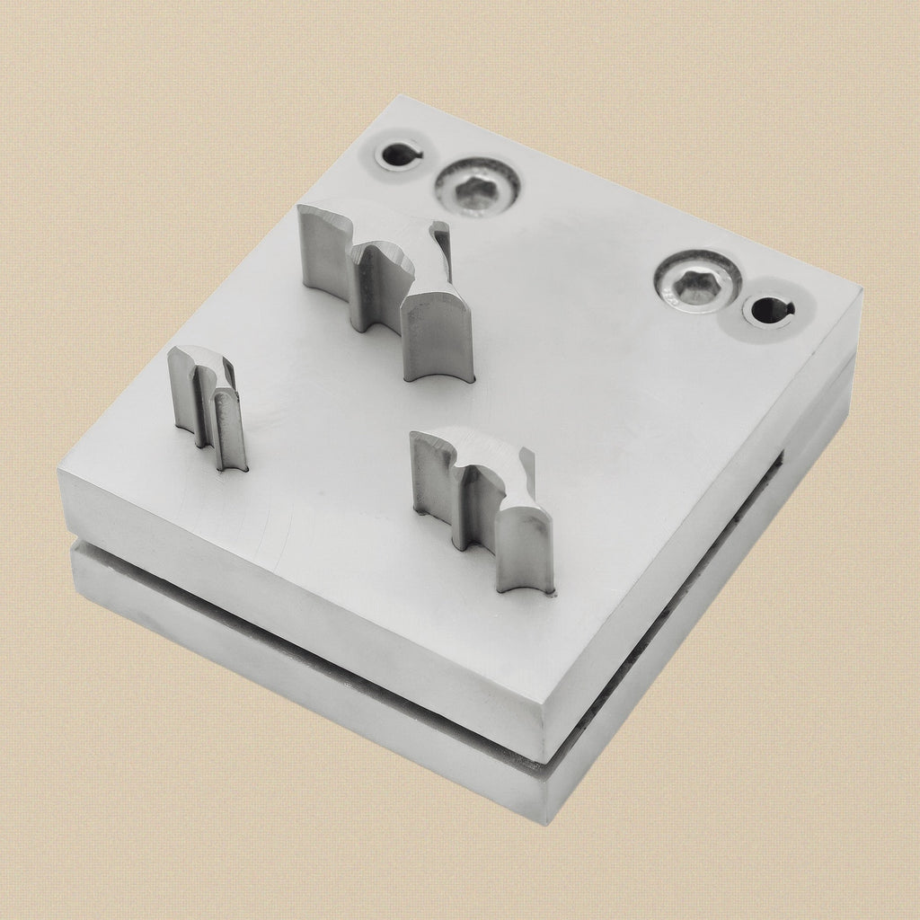 Front view of the 3-punch dolphin shape disc cutter set, showing the steel block and three punches.