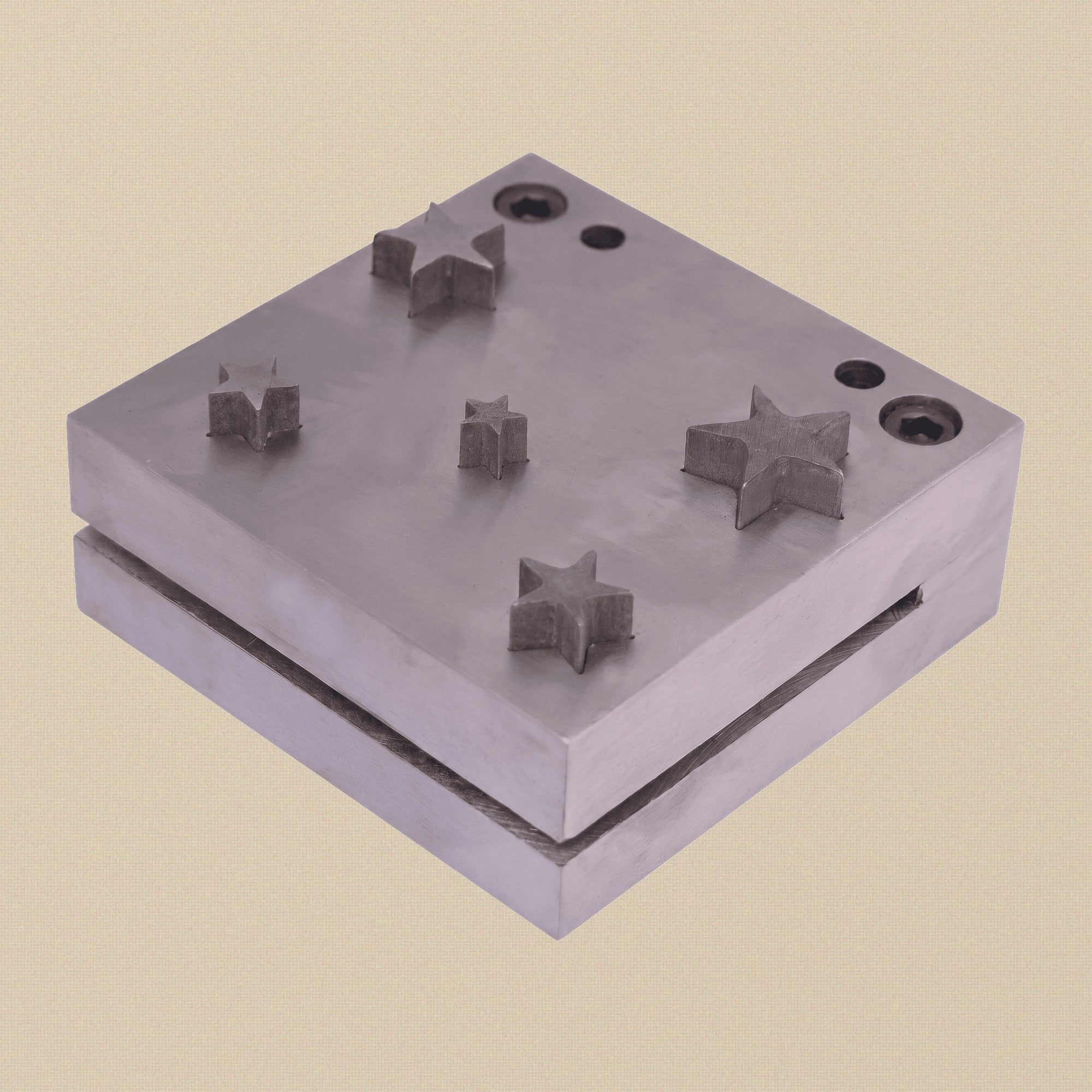 Five-pointed star disc cutter set showing the steel die block and five punches arranged neatly.