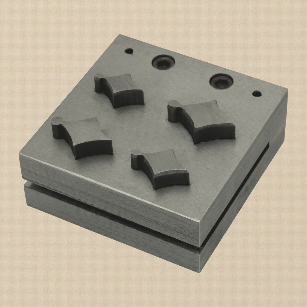 Kite shape disc cutter set with four punches arranged next to the steel die block.