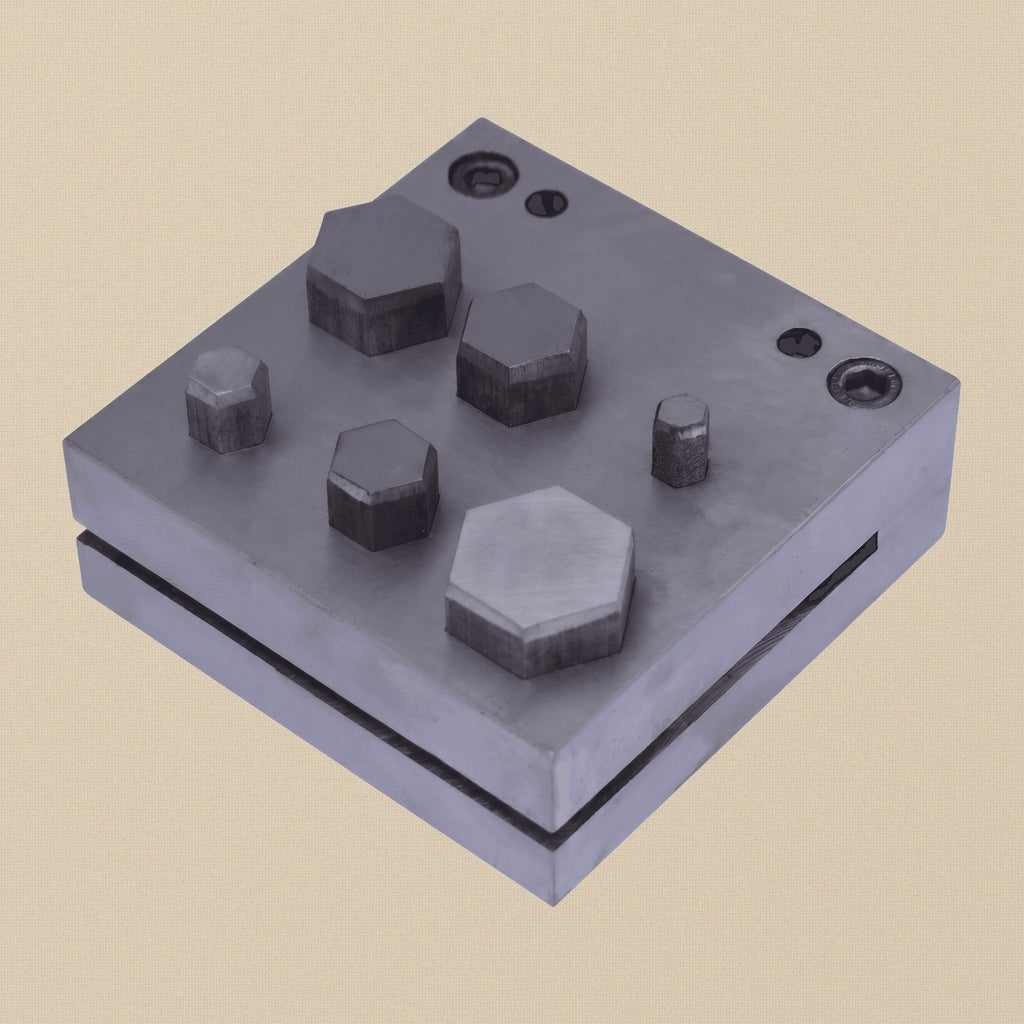 Hexagon disc cutter set with six punches arranged in the steel die block.