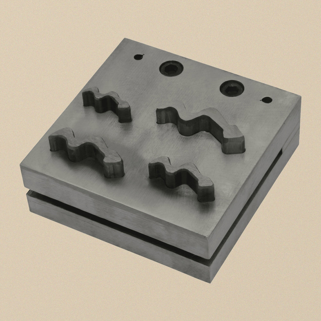 Snake design disc cutter set with four punches and steel die block on a white background.