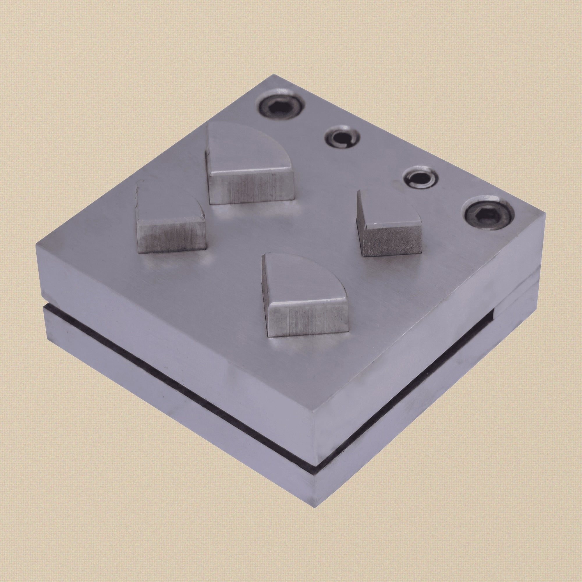 Carbon steel quarter circle disc cutter set with four punches and die block on a white background.