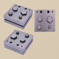 Hardened steel pentagon disc cutter set with four punches arranged next to the die block.