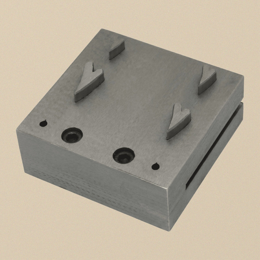 Narrow heart disc cutter set with four steel punches arranged next to the steel die block.
