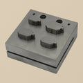 Hardened steel disc cutter block with four emerald-cut punches arranged neatly.