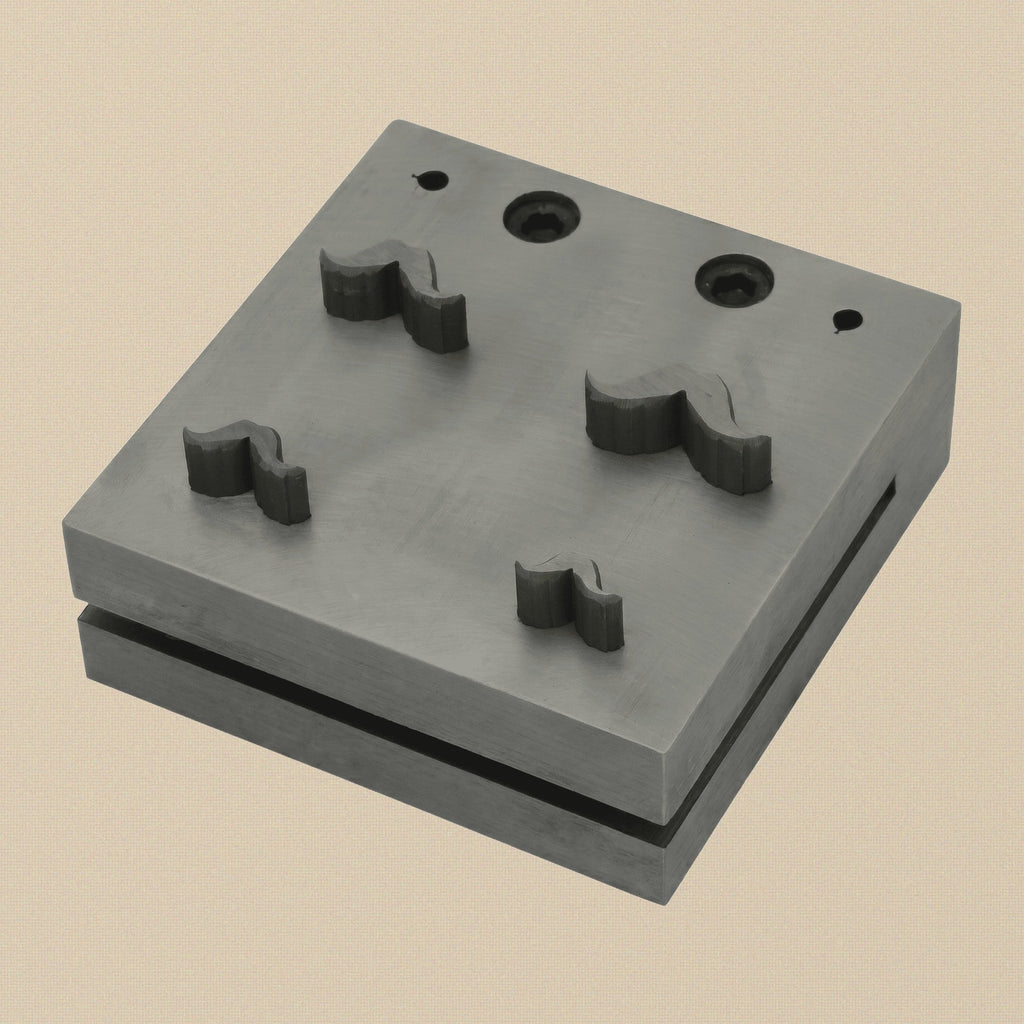 Four-punch mustache shape disc cutter set with hardened steel block and four punches arranged neatly.