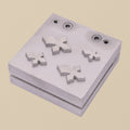 Gothic Cross disc cutter set showing the steel die block and four punches arranged neatly.
