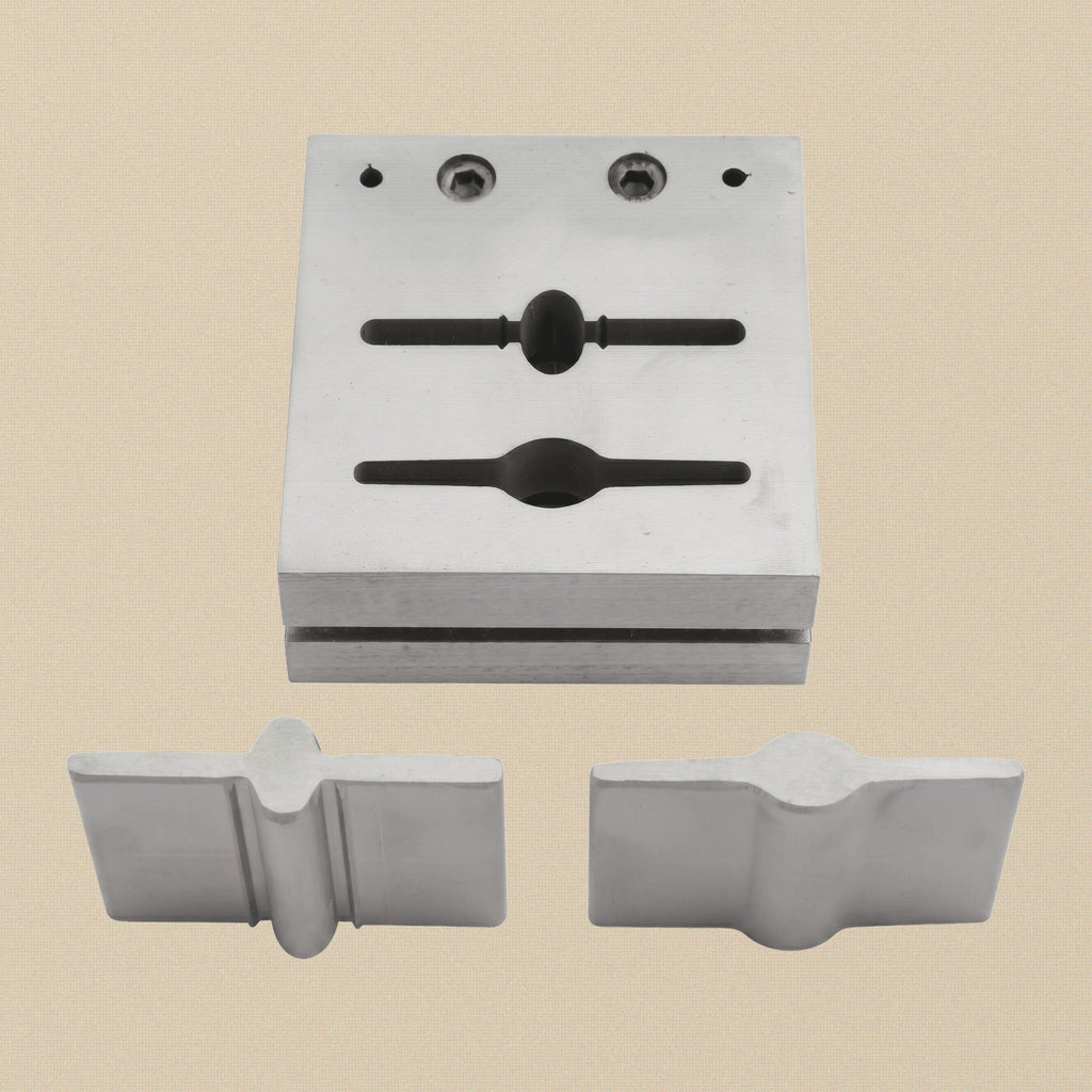 Bar and paddle disc cutter set with two punches and steel die block on a white background.