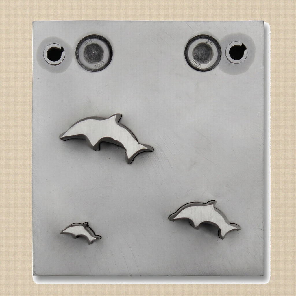 Overhead view of the tempered steel block, highlighting the three dolphin-shaped cutting slots.