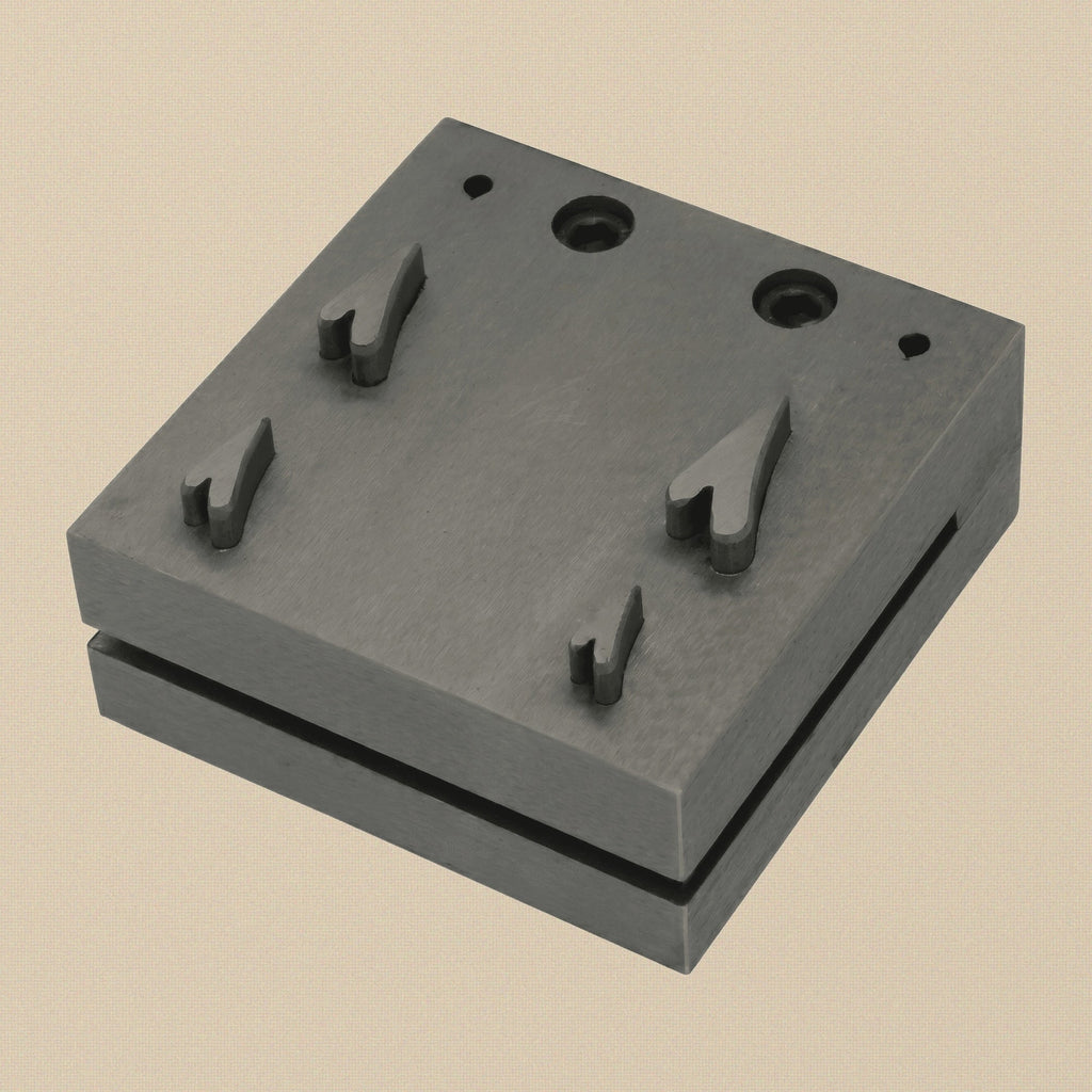 Close-up of the four narrow heart-shaped cutting slots in the hardened steel disc cutter block.
