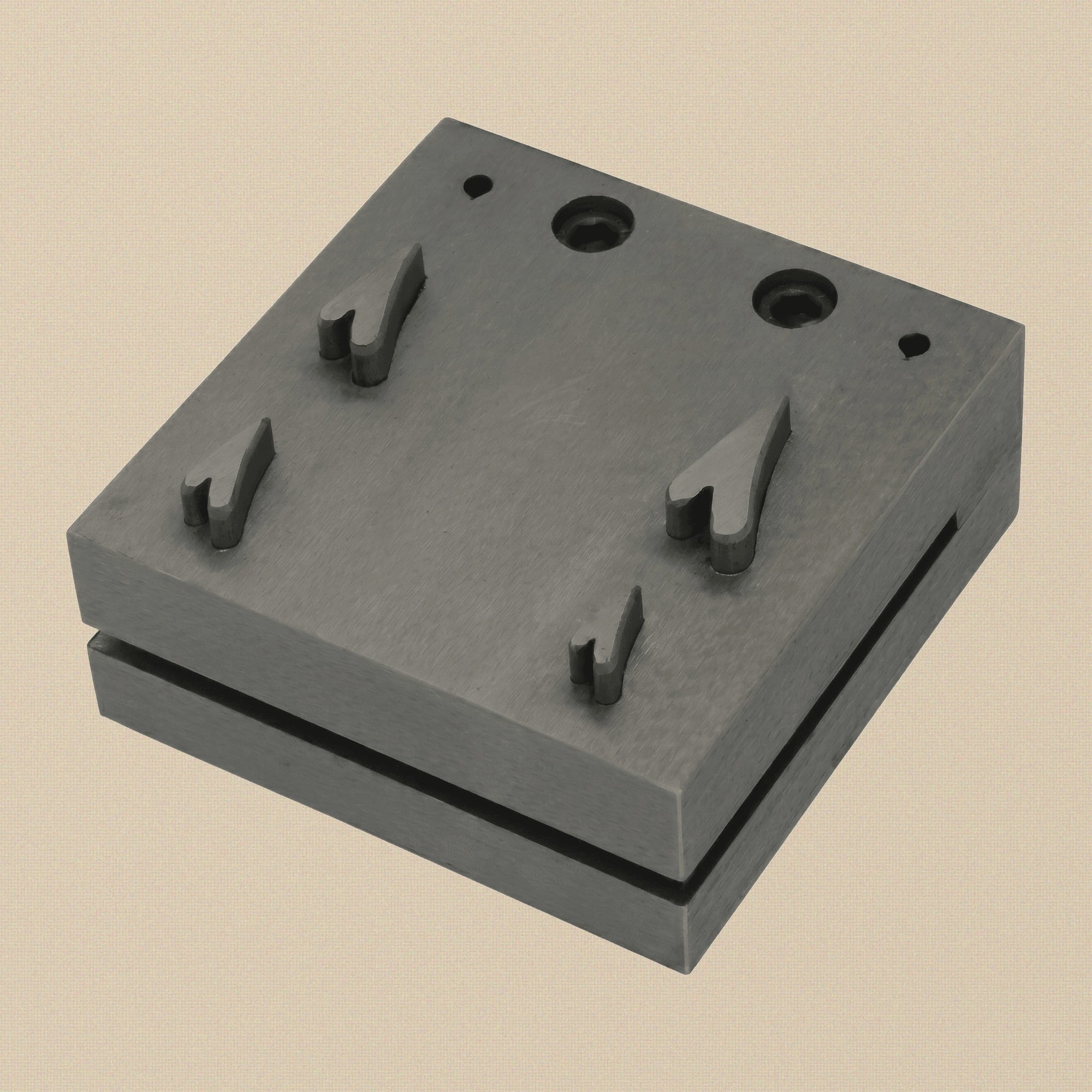 Close-up of the four narrow heart-shaped cutting slots in the hardened steel disc cutter block.