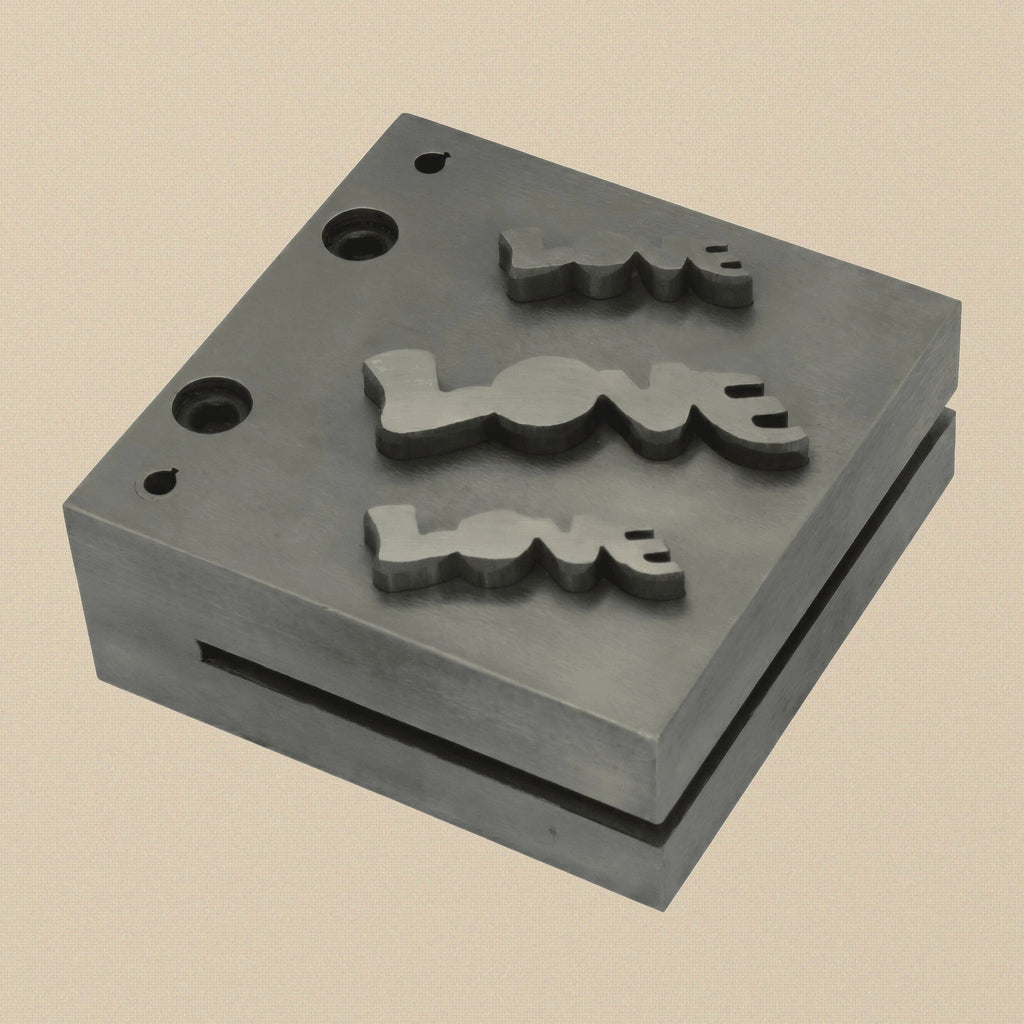 Top-down view of the 76mm hardened steel disc cutter block showing the three LOVE word shaped dies.