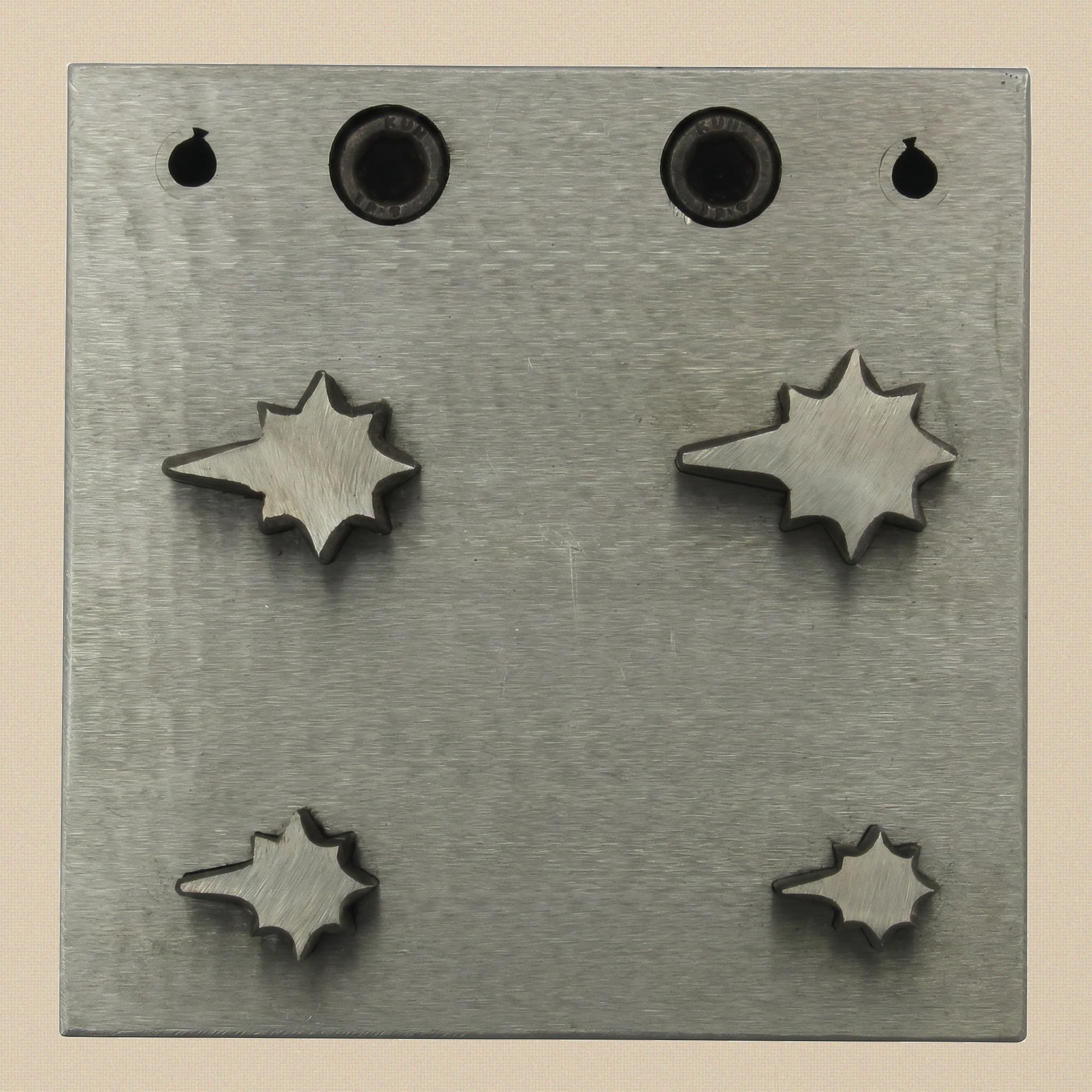 The four individual steel punches, showing the cutting edge and the hammered end.