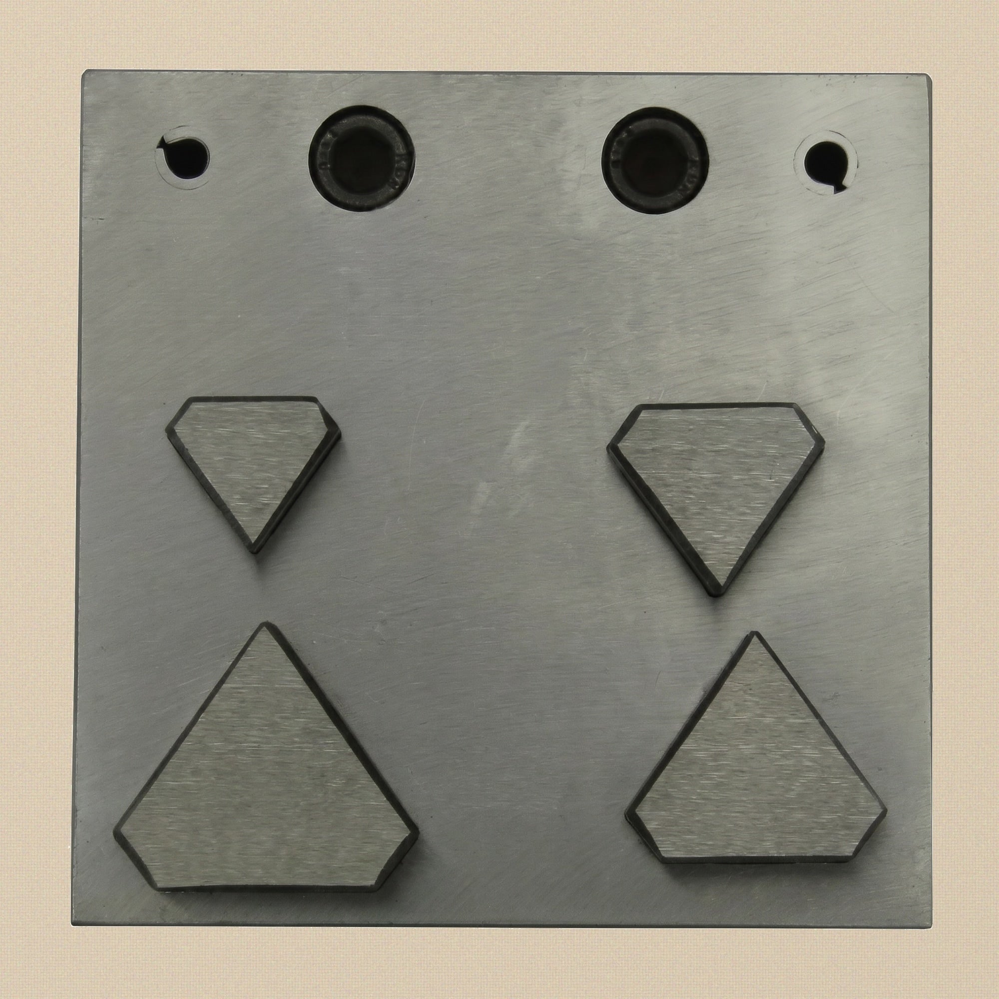 The four hardened steel punches showing the sharp cutting ends and bevelled striking ends.