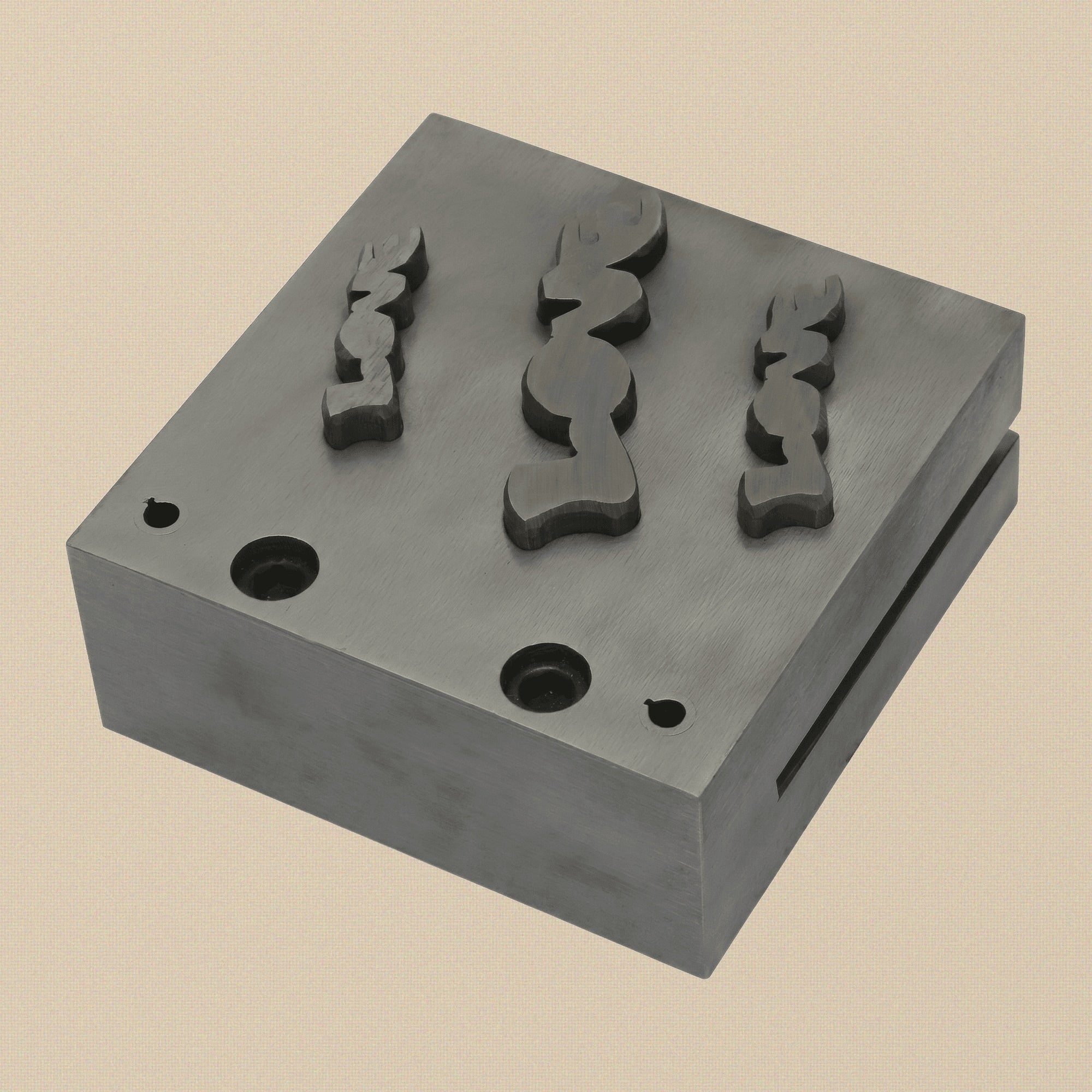 The three hardened steel punches for the LOVE word disc cutter set, showing striking and cutting ends.