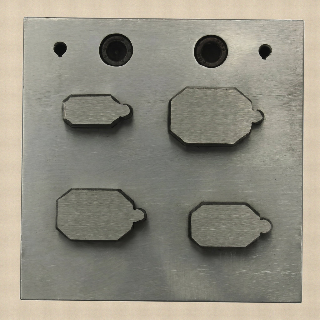 The four hardened steel emerald-cut punches showing the sharp cutting edge and struck end.