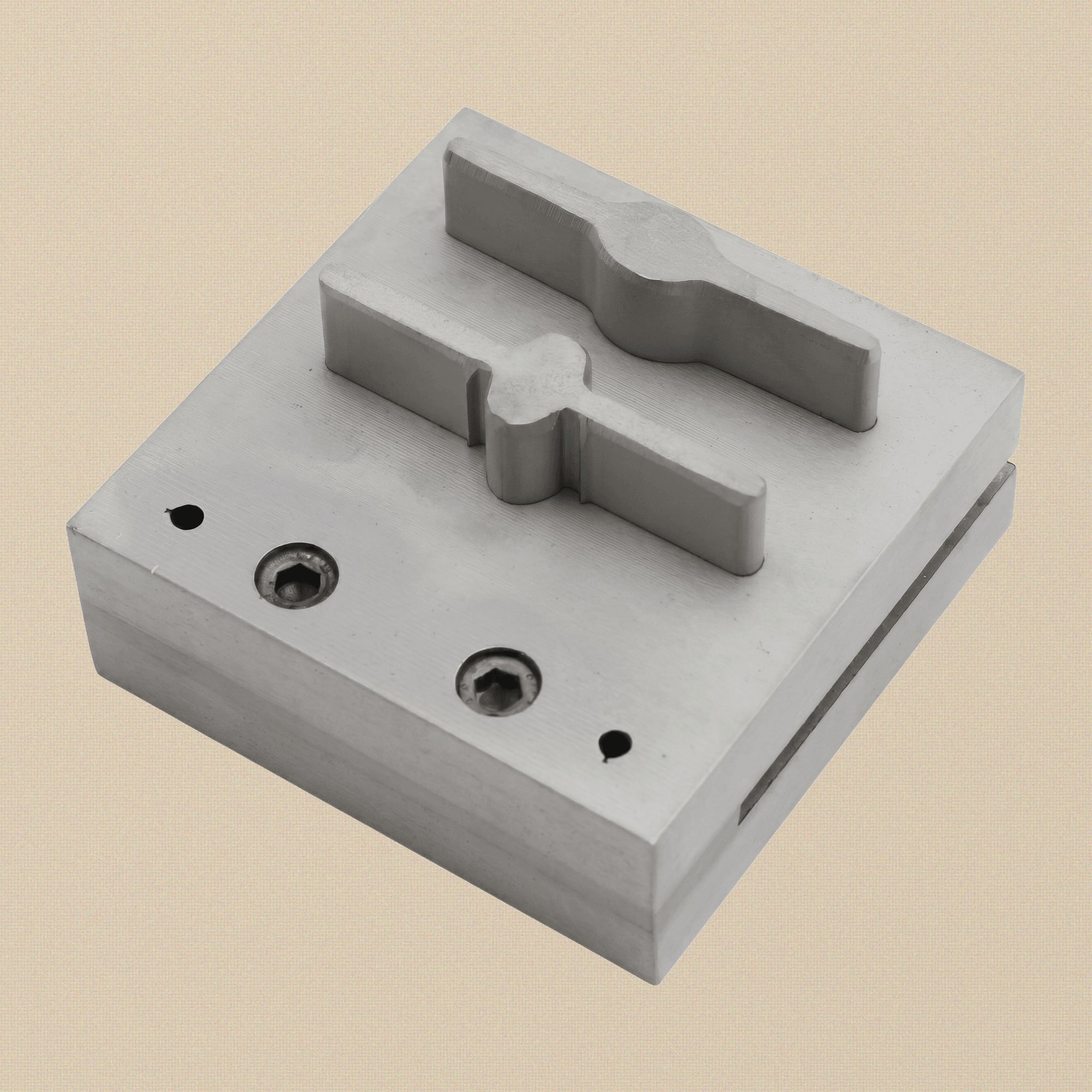 The two hardened steel punches, one bar-shaped and one paddle-shaped, showing cutting and striking ends.