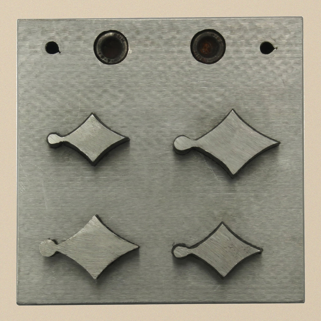 The four hardened steel punches for the kite disc cutter, showing cutting and striking ends.