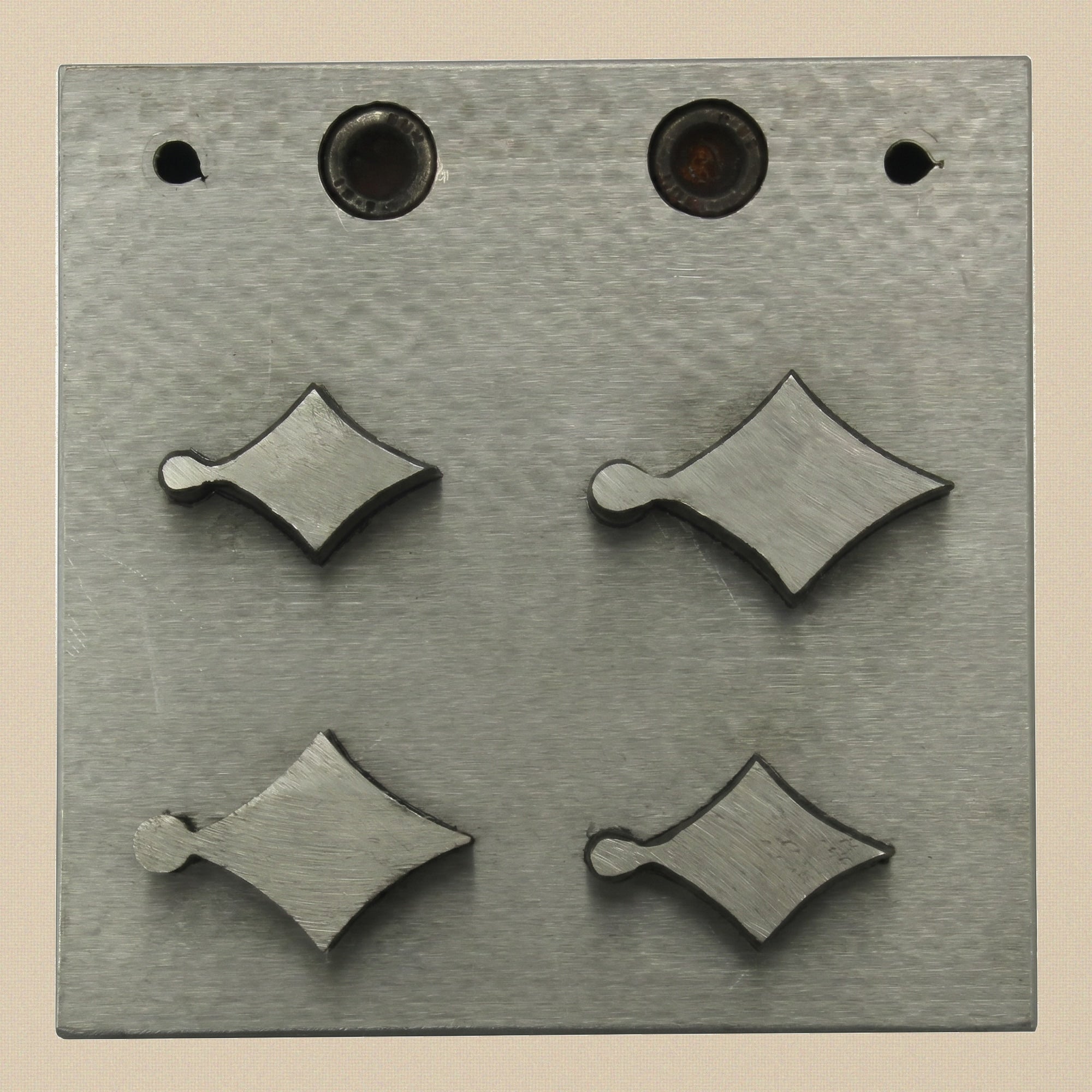 The four hardened steel punches for the kite disc cutter, showing cutting and striking ends.