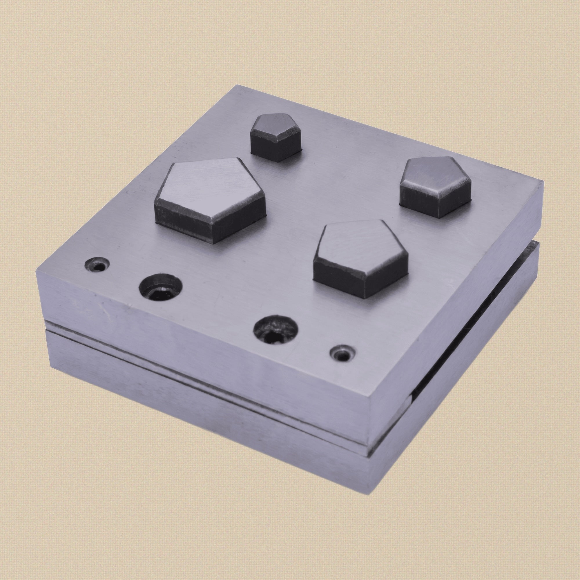 The pentagon disc cutter set with a ruler for scale, showing the 76 mm square block.