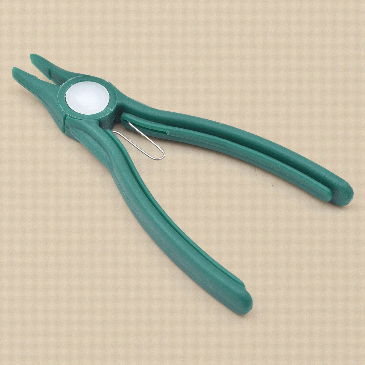 Green plastic flat nose pliers at an angle