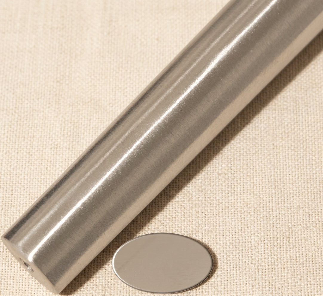 Close-up of solid steel oval ring shaping tool showing tapered mm dimensions