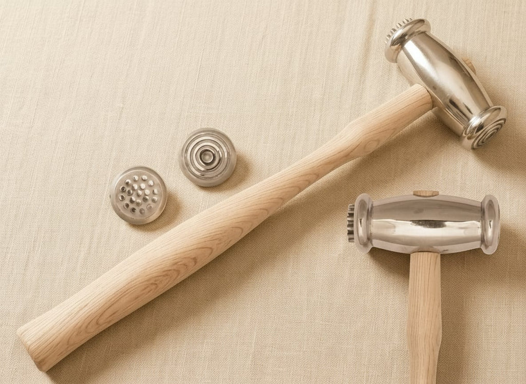 Dual-sided texturing hammer for jewellery making, featuring wide circles and dots on a wooden handle.