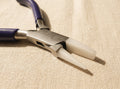 Close-up of the round and flat nose pliers' replaceable nylon jaws, ideal for wirework.