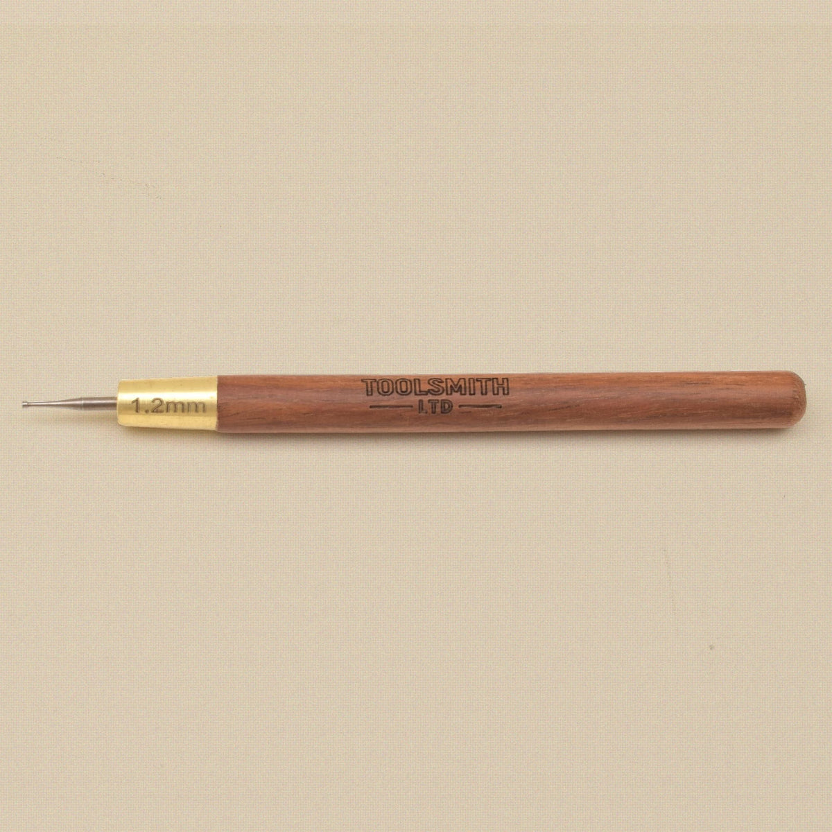 Wire rounder lying flat showing the wooden handle and brass ferrule