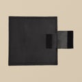 Black leather sand bag, 10 x 10 inch square, unfilled, seen from above