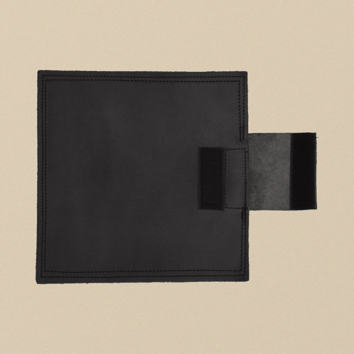 Black leather sand bag, 8 x 8 inch square, unfilled, seen from above