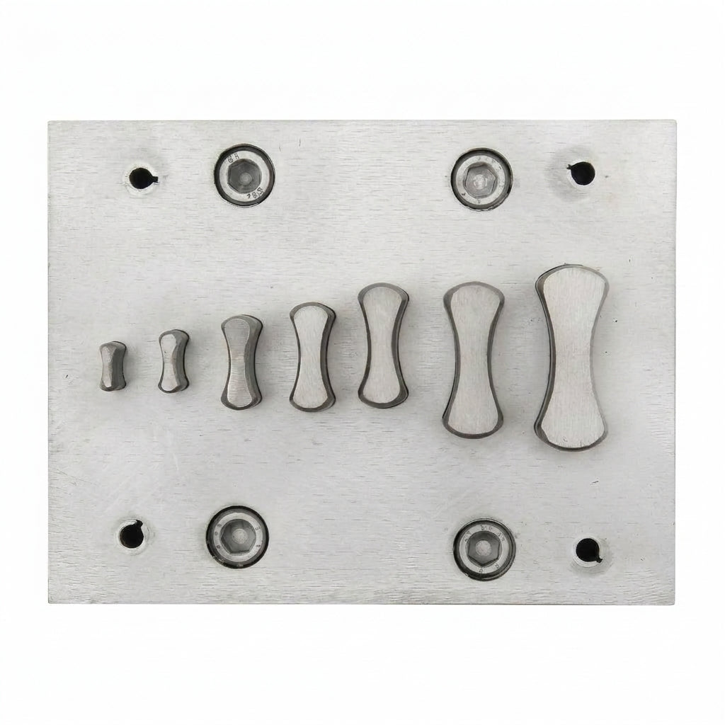Close-up of the bone-shaped steel disc cutters showing their polished finish and forming edges.