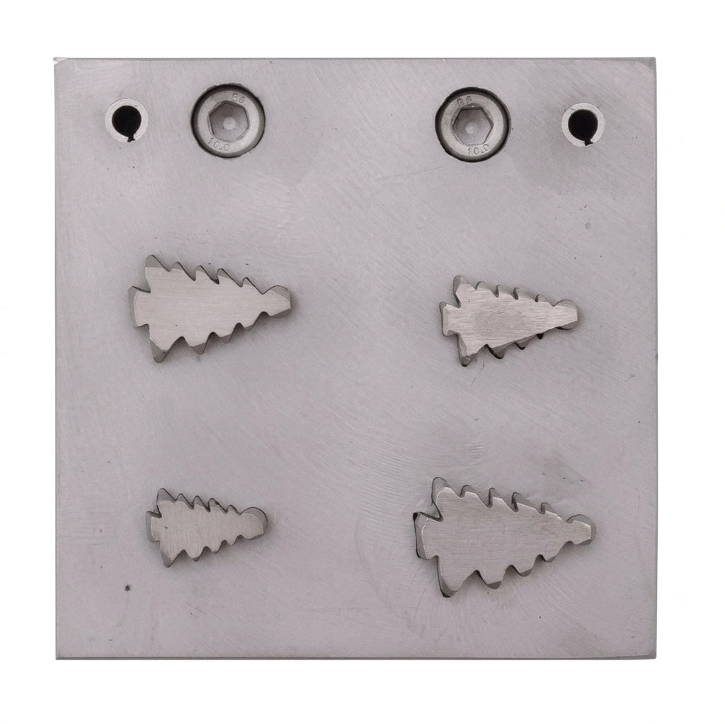Close-up of the four Christmas tree shaped steel disc cutters for jewellery making.