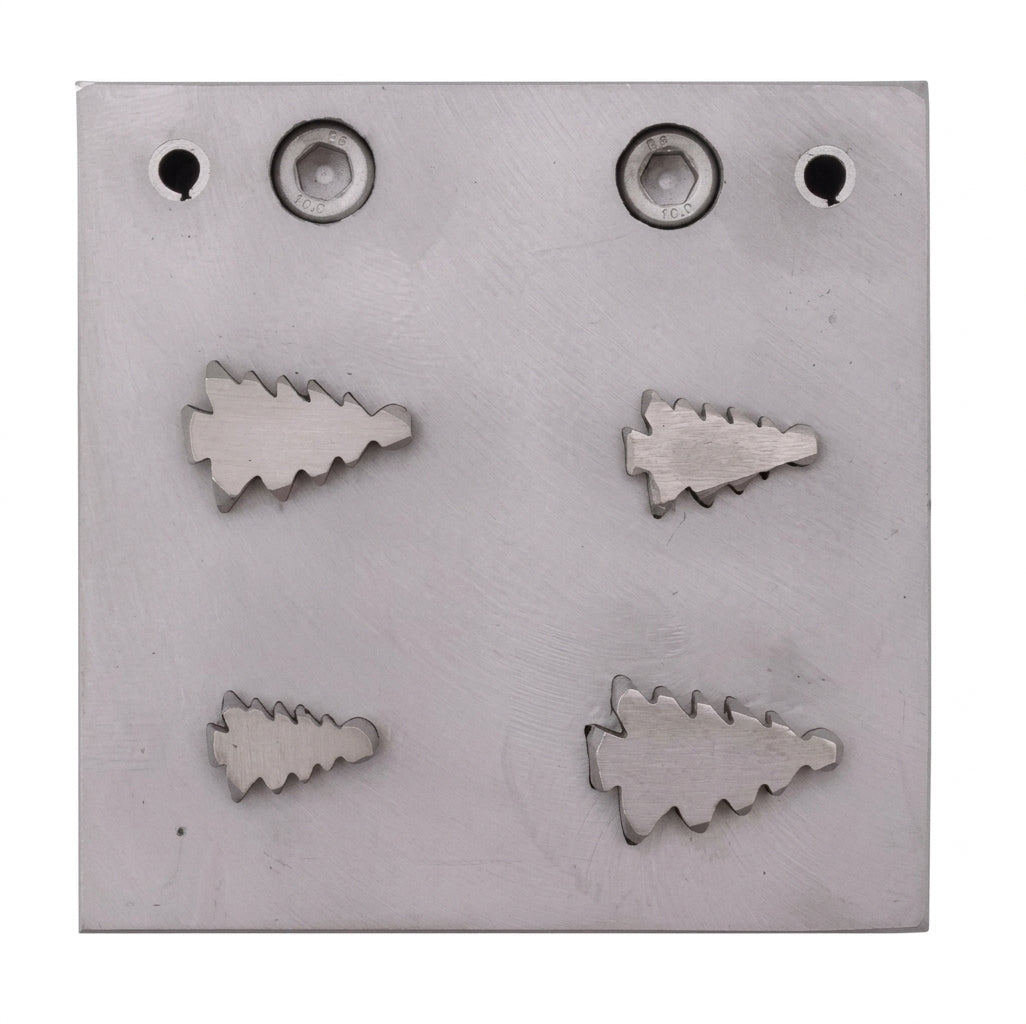 Close-up of the four Christmas tree shaped steel disc cutters for jewellery making.