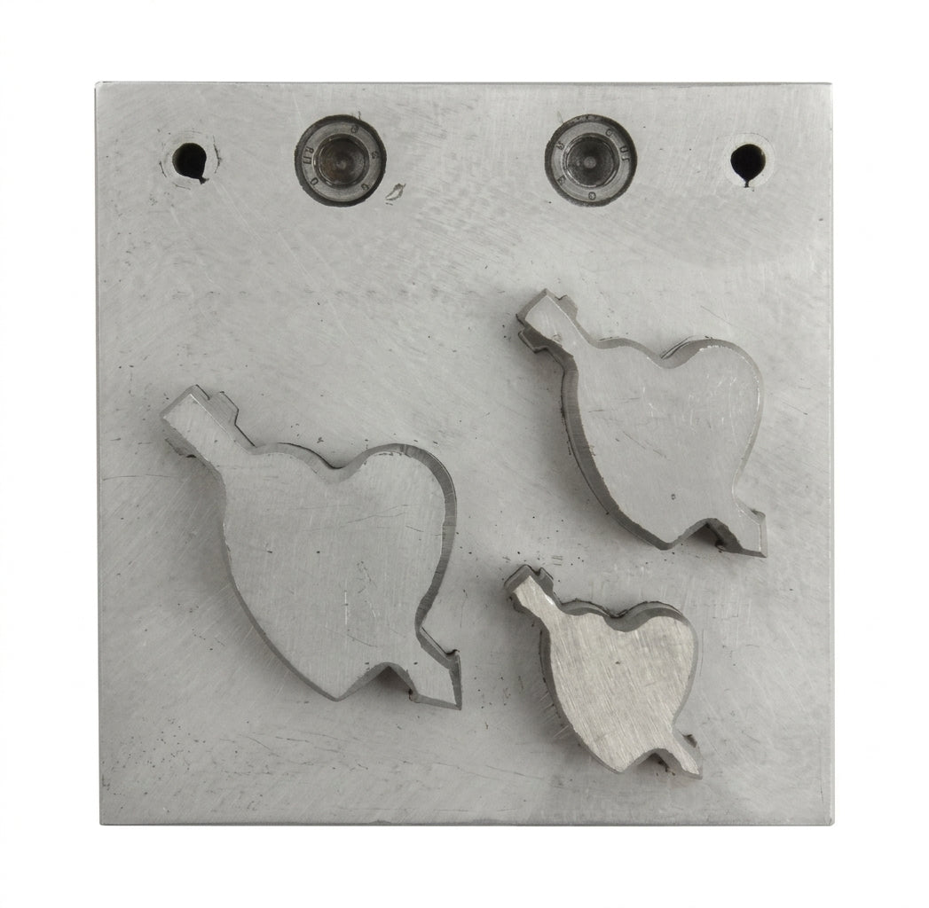 Close-up of the three steel heart-and-arrow punch cutters in graduated sizes.
