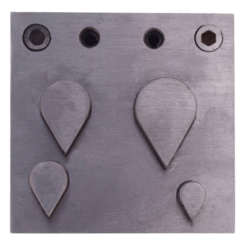 Close-up of teardrop punch shapes in steel disc cutter set, 4 sizes 10-33mm
