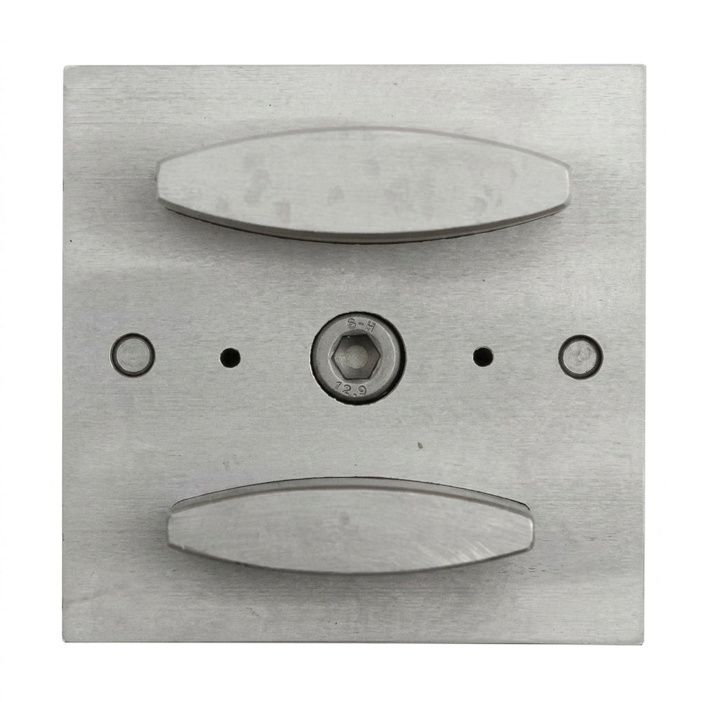 Close-up of the narrow oval punch shapes of the steel disc cutter.