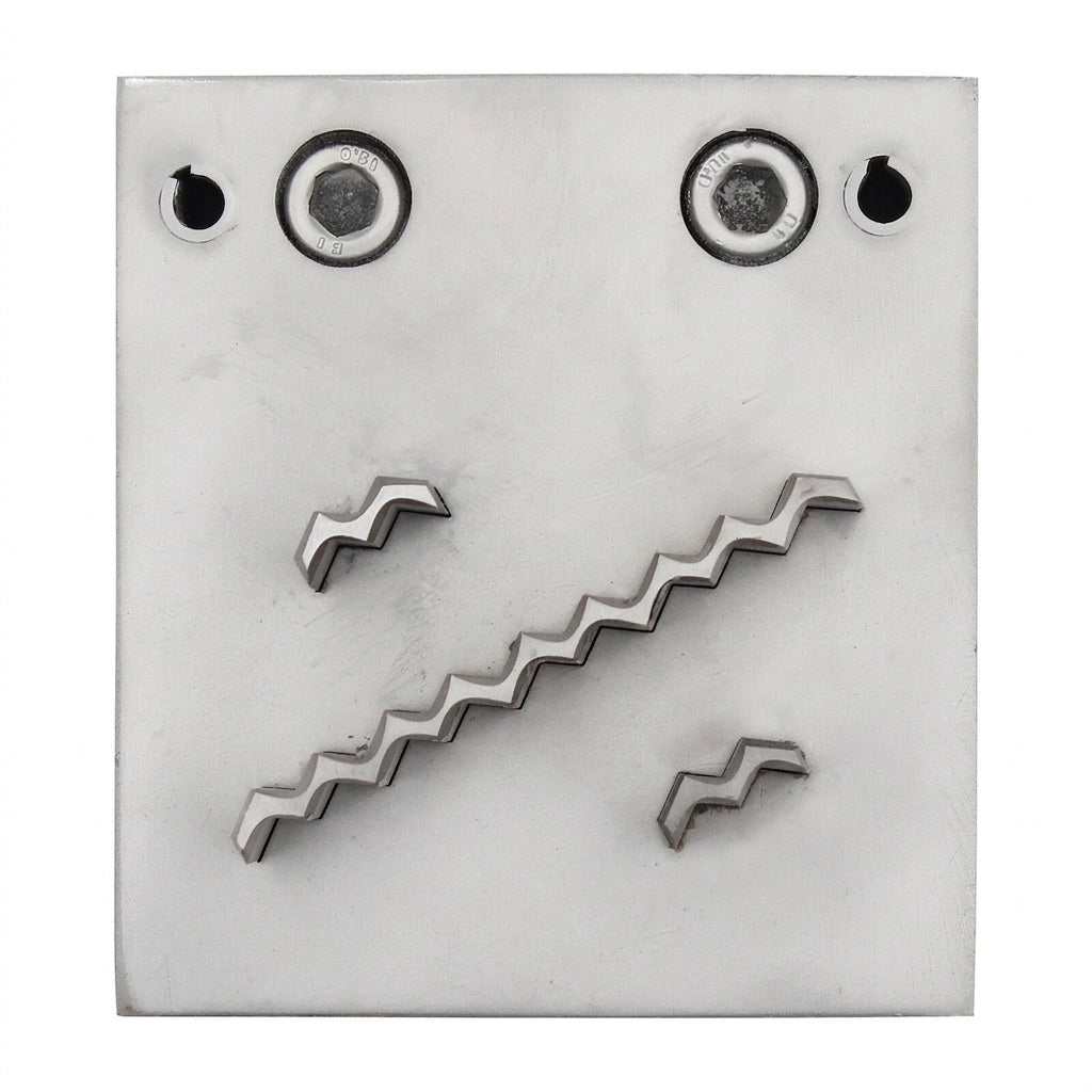 Close-up of the steel disc cutter's three wave-shaped punch slots for creating stamped blanks.