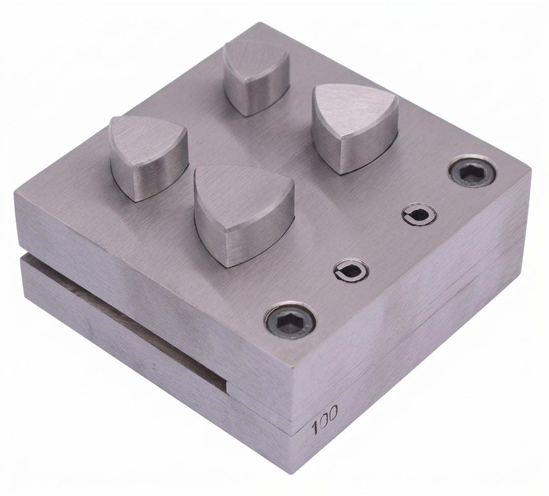 Close-up of a curvilinear triangle punch from the set, showing the sharp cutting edge for disc creation.