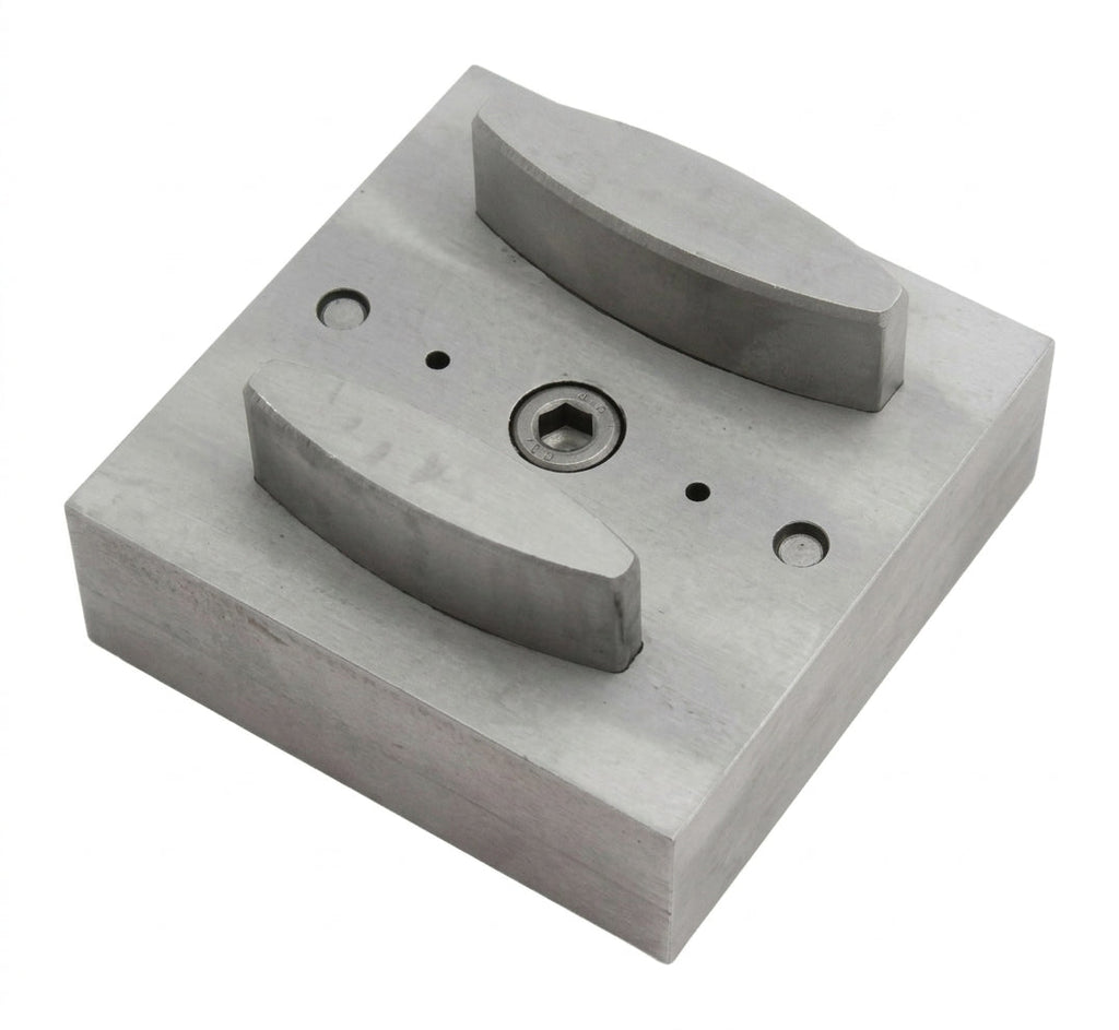 Close-up of the narrow oval steel disc cutter's punch openings and base.