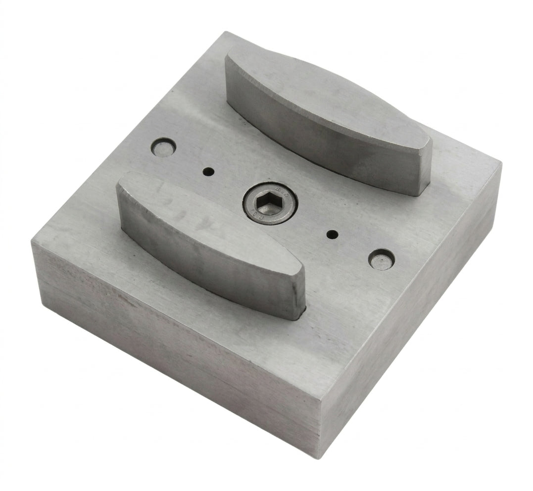Close-up of the narrow oval steel disc cutter's punch openings and base.